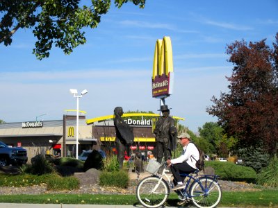 McDonald's Sign, Statue and Cyclist