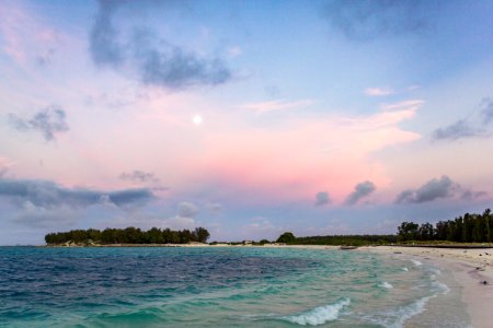 Full moon in the sunset as seen from the cargo pier