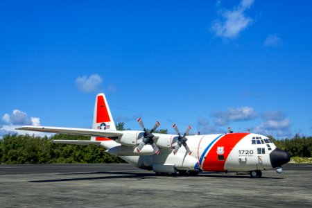 A U.S. Coast Guard C-130 parked in front of the NAF Hangar