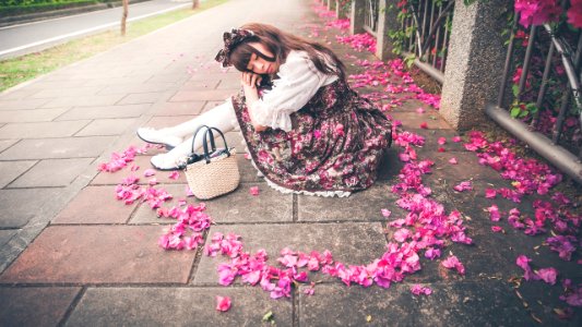 NIKON D700 Taiwanese woman sleeps surrounded by scattered bougainvillea flowers photo