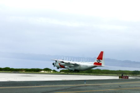 A U.S. Coast Guard C-130 takes off from Midway Atoll National Wildlife Refuge