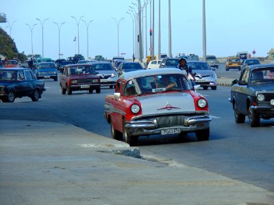 Havana. Seafront with red almendrón