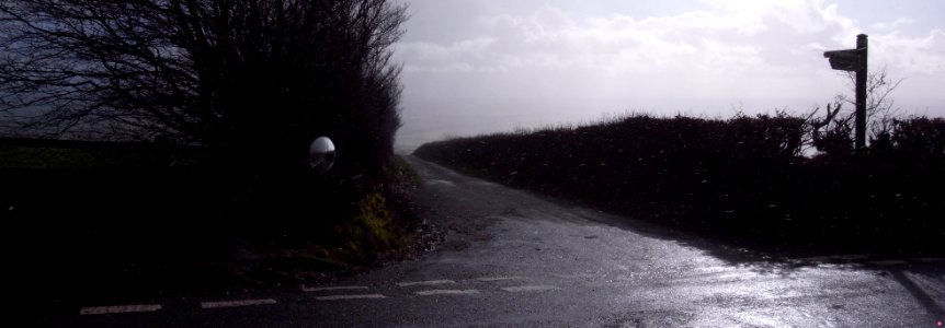 WINTERY SHOWER -ROAD MIRROR - EXMOOR - UK. -