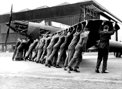 Trainees push a Fairey Battle to a hangar at 2 School of Technical Training at Cosford, Shropshire 1940. photo
