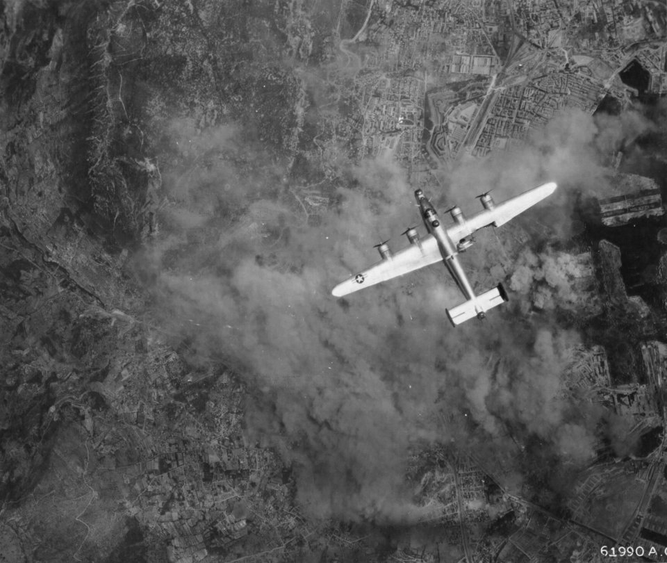A damaged B-24 Liberator from the  376th American bombardment in flight over Toulon 1944.