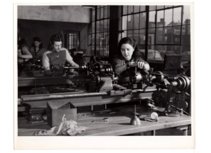 "Girls working on metal lathes"