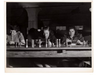 "Girls working on metal lathes"