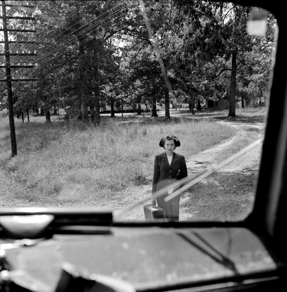 Going Places: A Girl waiting for the bus by a road's edge. Greyhound bus trip from Louisville, Kentucky, to Memphis, Tennessee, and the terminals. September 1943.