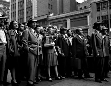 Invasion!: Pedestrians watching news of the Normandy Invasion on an electric marquee near Times Square on D-Day, June 6, 1944. New York, New York.
