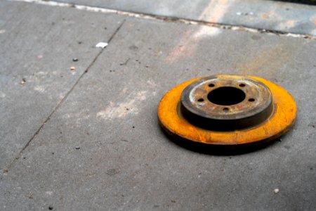 Rusty rotor on Wall Street sidewalk photo