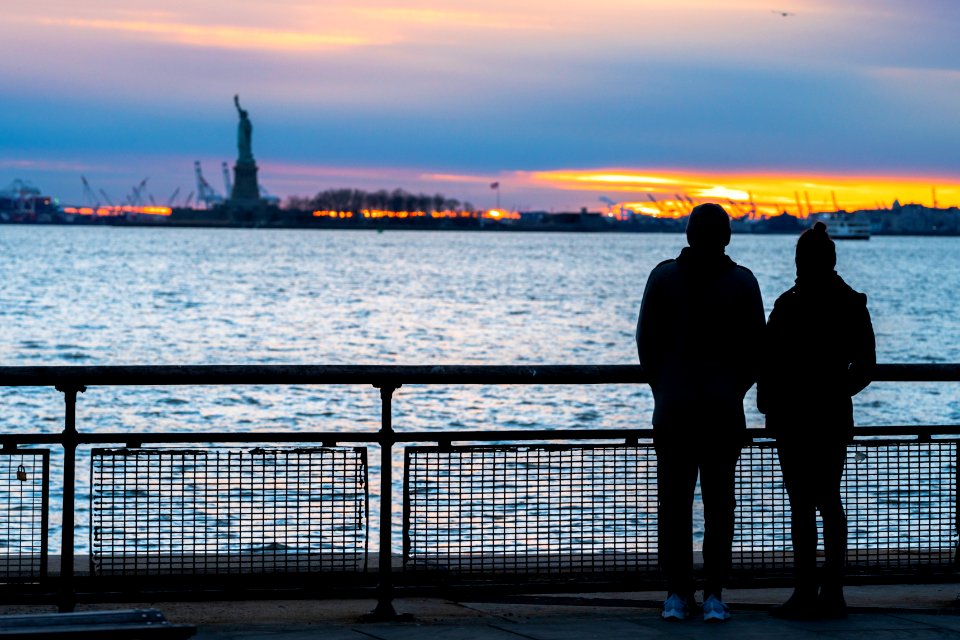 A couple watching the sunset at Battery Park