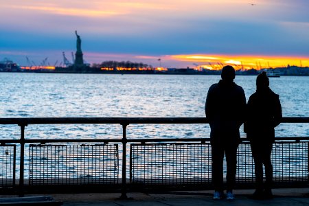 A couple watching the sunset at Battery Park photo