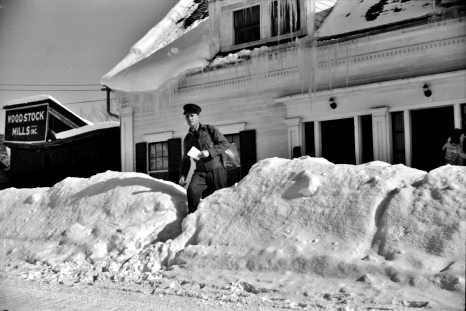 Mailman making deliveries after a heavy snowfall. Woodstock, Vermont, 1940.