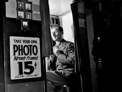 Ready for His Close-up: A picture-taking machine in the lobby at the United Nations service center. Washington, D.C., 1943.
