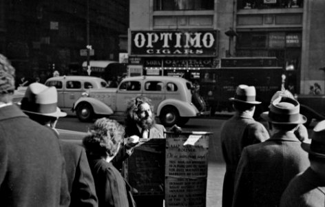 Group of men on 7th Avenue and 28th Street, New York City, November 1936.