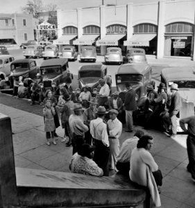 Streetside Congregation: Outside the Labor Temple where the conference called by the Steinbeck Committee during the cotton strike is being held. Bakersfield, California. November 1938.