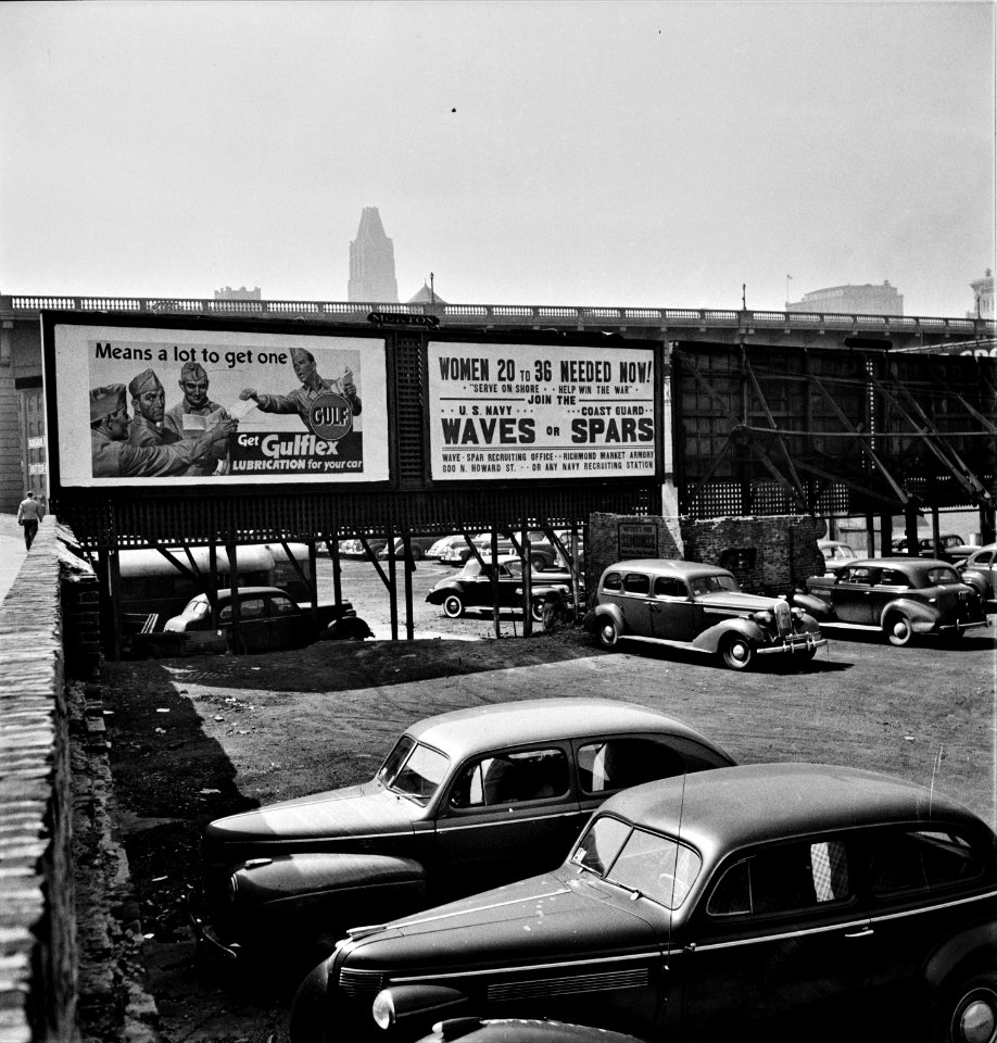 Waves, Spars, & Cars: Parking lot and billboards in Baltimore, Maryland. April 1943.