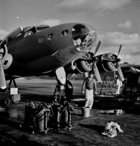 Lubricating and servicing a new B-17F (Flying Fortress) bomber for flight tests at the airfield of Boeing's Seattle plant, 1942. photo