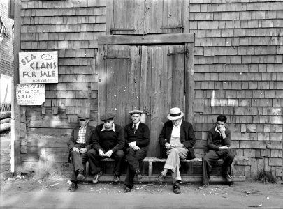 The Sand Bar Club, a bench on the waterfront main street which is occupied all day by fishermen, unemployed fishermen and other residents with nothing to do. Here, they gossip, whittle, and make remarks about passing tourists. September 1940.