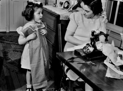 'Can I wear it today?': A domestic scene between mother and daughter. February 1942. This photo was taken as part of a series to inform the public on tips for the conservation of resources during wartime. Original caption below. photo