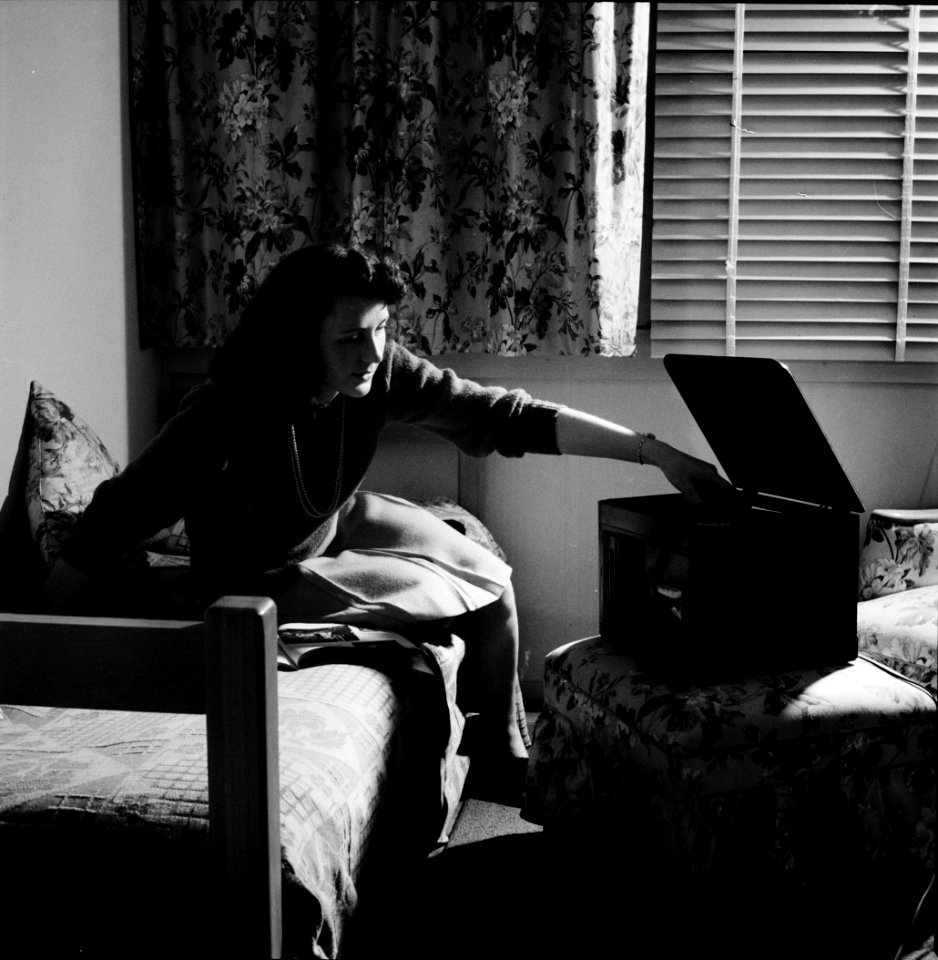Afternoon Serenade: Arlington, Virginia. A girl in her room playing a phonograph at Arlington Farms, a residence for women who work in the government for the duration of the war. June 1943.