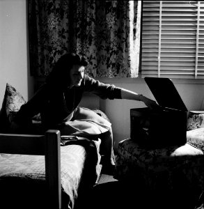 Afternoon Serenade: Arlington, Virginia. A girl in her room playing a phonograph at Arlington Farms, a residence for women who work in the government for the duration of the war. June 1943.