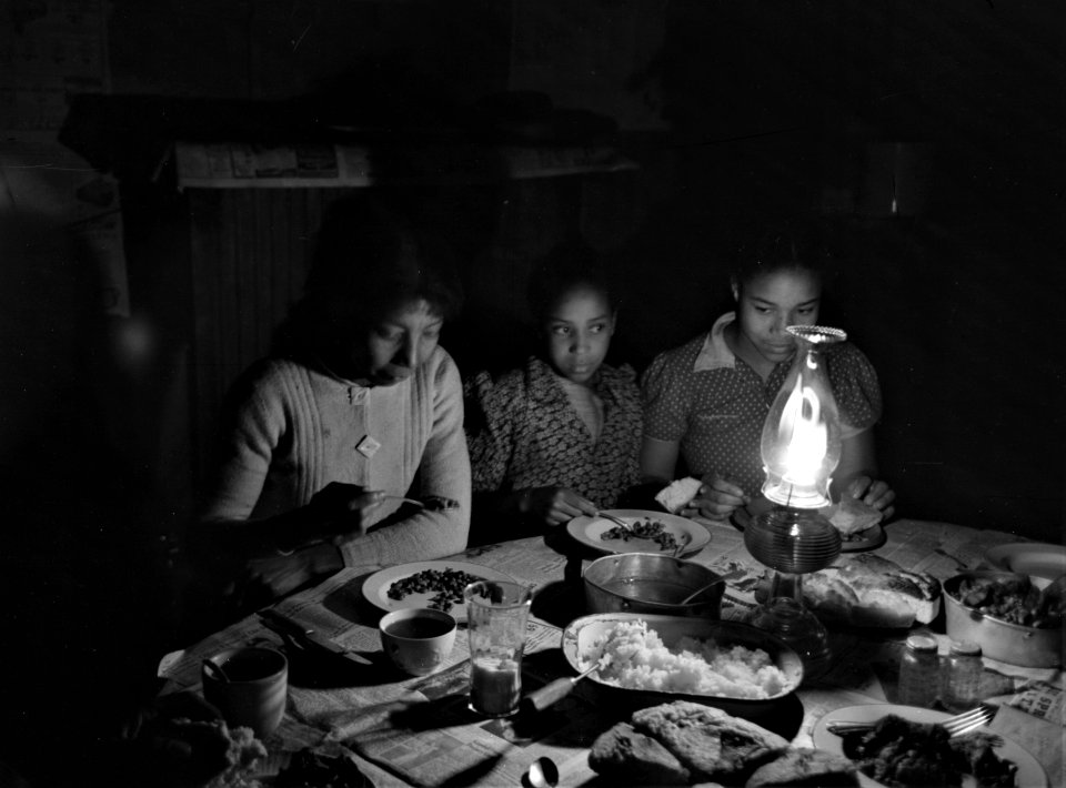Little Light of Mine: Part of Pomp Hall's family eating supper by lamplight, Creek County, Oklahoma. February 1940.