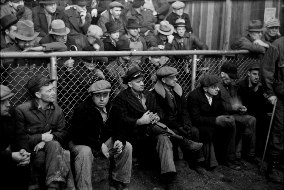Farmers sitting inside the sales ring of a livestock sales hall Ames, Iowa, November 1936