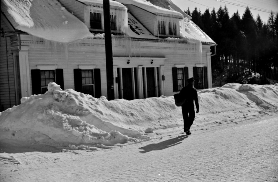 Mailman making deliveries after a heavy snowfall. Woodstock, Vermont, 1940.