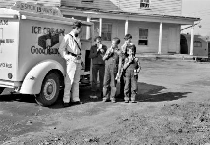 Good Humor: The Good Humor man comes to a trailer camp on Saturday afternoon. These children are sons of torpedo plant workers in Alexandria, Virginia, March 1941.