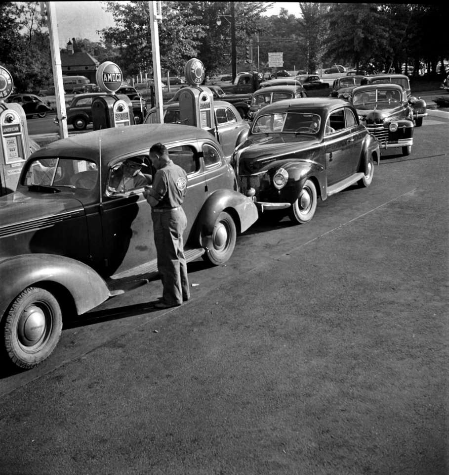 Morning of July 21st, the last day before stricter gas rationing went into effect, cars were parked in front of gas stations long before they opened, waiting to fill their tanks. Washington D.C., 1942.