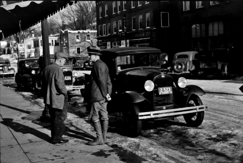 Townspeople of Woodstock, Vermont, discussing the severe winter on the street corner in center of town, 1940.