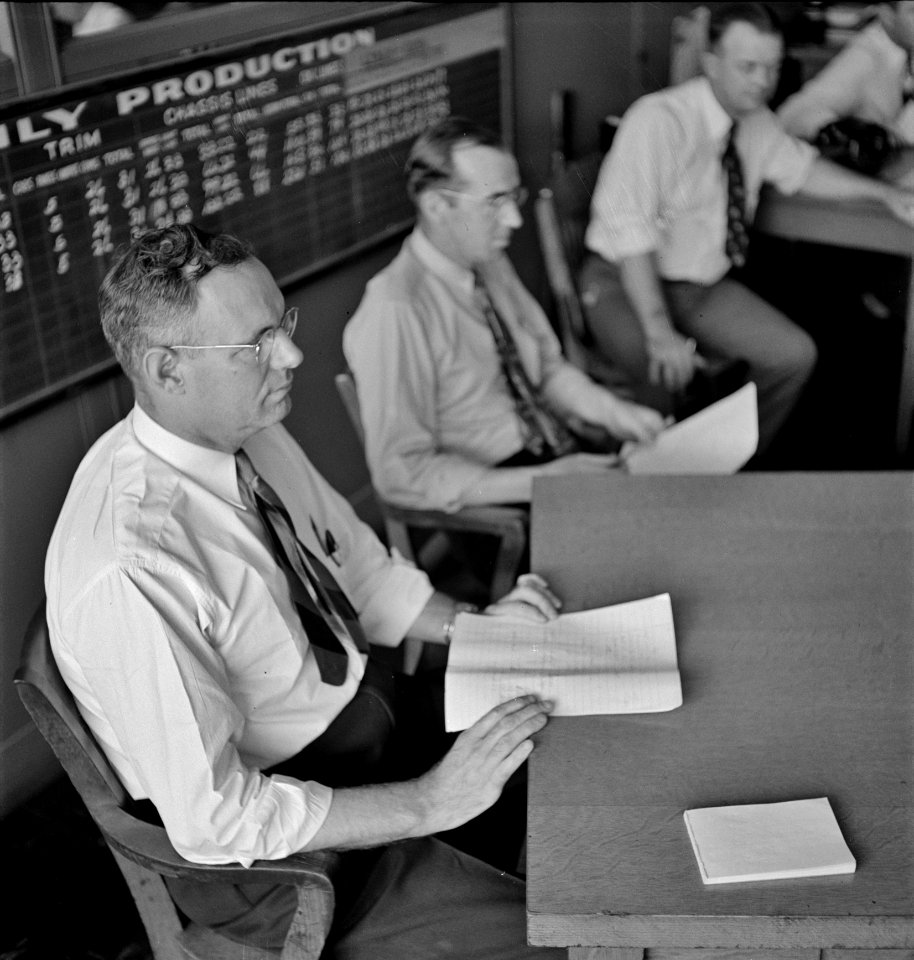 Work Flows: A meeting at the Chrysler Corporation Dodge truck plant. Careful check is kept of every detail of production. Detroit, Michigan, 1942