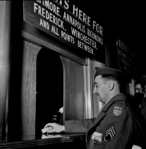 Washington, D.C. Soldier buying a ticket at the Greyhound bus depot. April 1943.