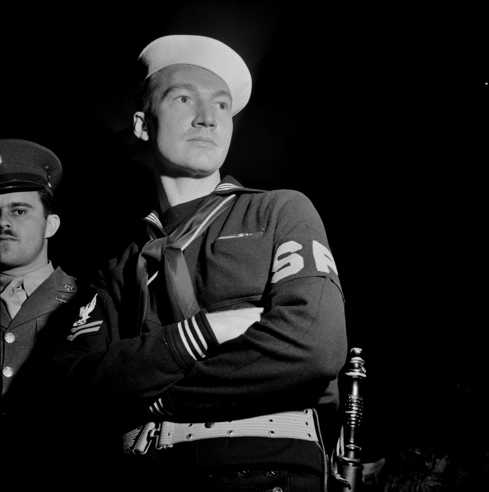 Shore Patrol: Washington, D.C. Member of the Shore Patrol who helps get servicemen lined up and in order while waiting for special buses to leave the Greyhound bus terminal on Sunday evenings. April 1943.