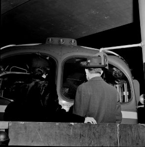 One Last Look: Parents of one of the soldiers on a special bus, climbing onto the baggage cart to look into the bus until the moment it departs from the Greyhound terminal 1943.