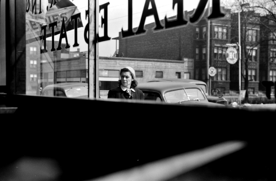 Passerby: Looking out of a building on 47th Street in Chicago, Illinois. 1941.