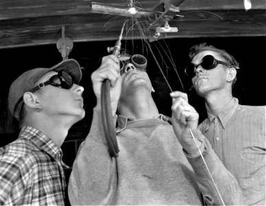 Look Here: Instructor C.C. Gravelge, showing one of his classes the difficult art of overhead welding in preparation for their initiation into aircraft welding jobs . Former nightclub in Daytona Beach, Florida April 1942.