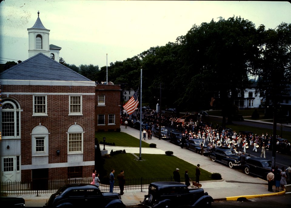 Wars, Past & Present: Memorial Day parade moving down the main street in Southington, Connecticut, May 1942. The small number of spectators is accounted for by the fact that the town's war factories did not close for the holiday.