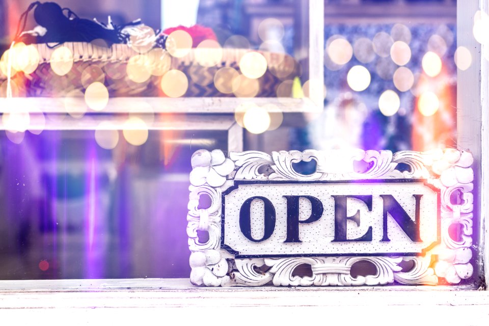 Open sign in clothing store.