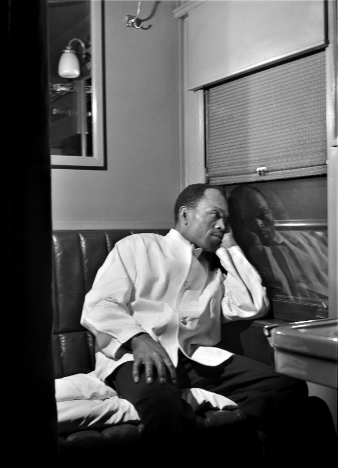 Through the Night: Alfred MacMillan, Pullman porter, resting in the men's washroom aboard the 'Capitol Limited' bound for Chicago, Illinois, March 1943.
