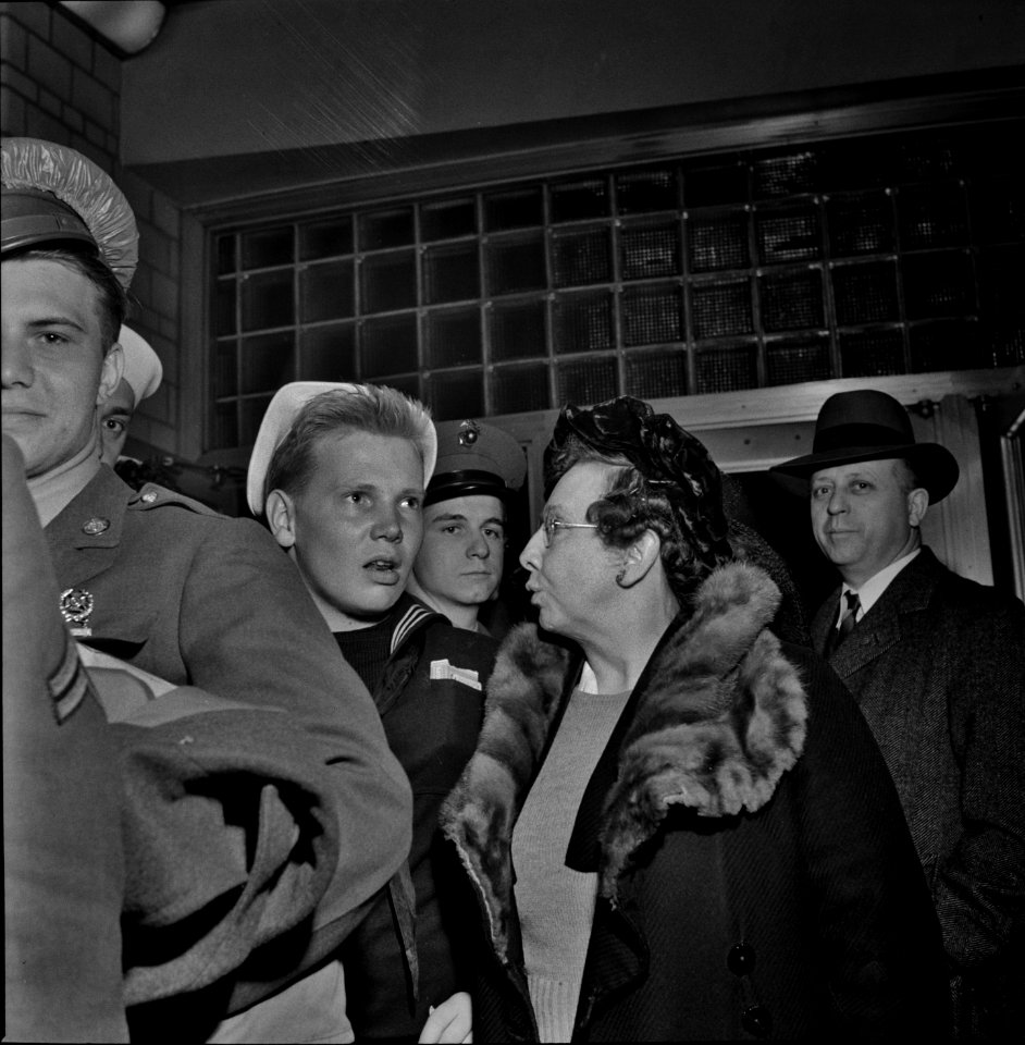 Now Be A Good Boy: Washington, D.C. Woman standing in line with her son until he leaves on the bus at the Greyhound bus depot. April 1943.