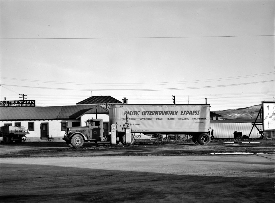 On the Way to Somewhere: Trailer & truck at a gas station in Elko, Nevada, March 1940.