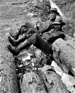 Sit Anywhere: Woodsman relaxing after lunch during the spring pulpwood drive on the Brown Company timber holdings in Maine. May 1943.
