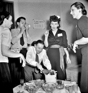 Happening Here: Serving punch during an evening party at the home of a government artist. Washington, D.C. June, 1942