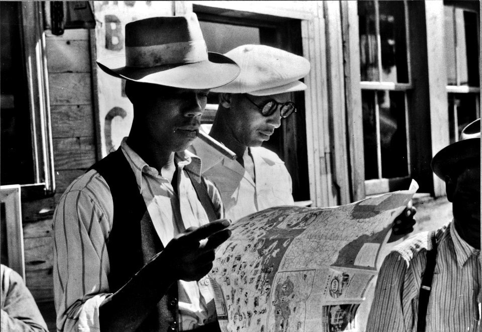 Map Quest: Florida migrants studying a road map before leaving Elizabeth City, North Carolina for the state of Delaware, 1940.
