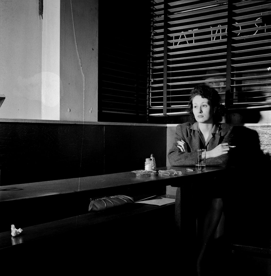 Nighthawk: Girl sitting alone in the Sea Grill, a bar and restaurant, waiting for a pickup. Washington D.C., April 1943. Photo by Esther Bubley.