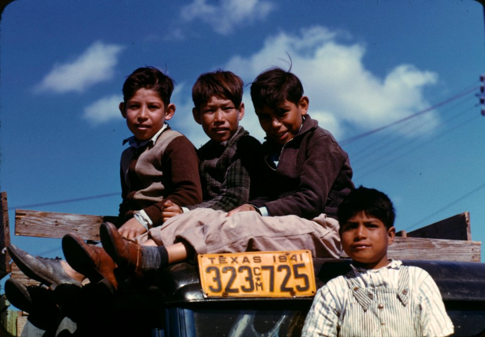 Boys sitting on truck parked at the Farm Security Administraton labor camp. Robstown, Texas, 1941.