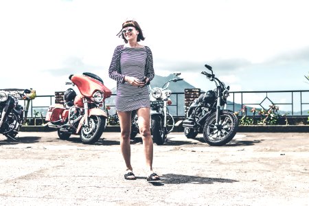 BALI, INDONESIA - AUGUST 12, 2018: Woman on the Harley Davidson motorcycles background, Batur volcano.