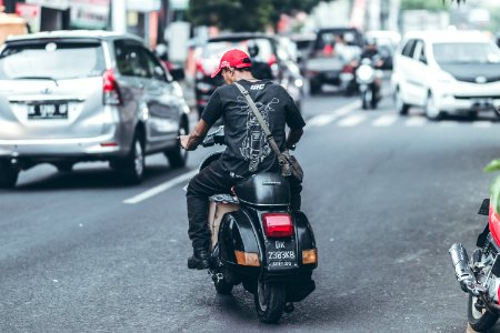 BALI, INDONESIA - MAY 17, 2018: : Road traffic on Bali. Ubud area. Mopeds on the streets. Motorbikes.